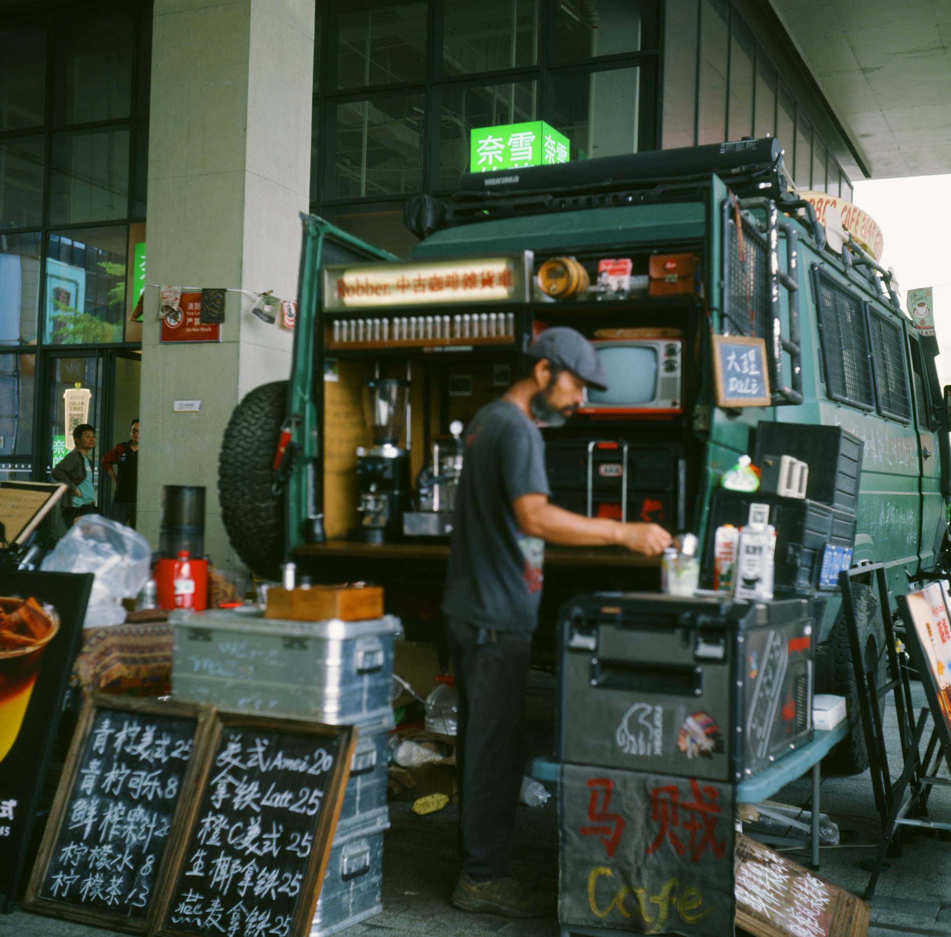 Man preparing drinks at a mobile coffee van